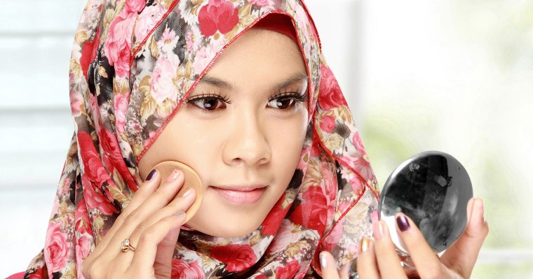 Muslim women putting on makeup